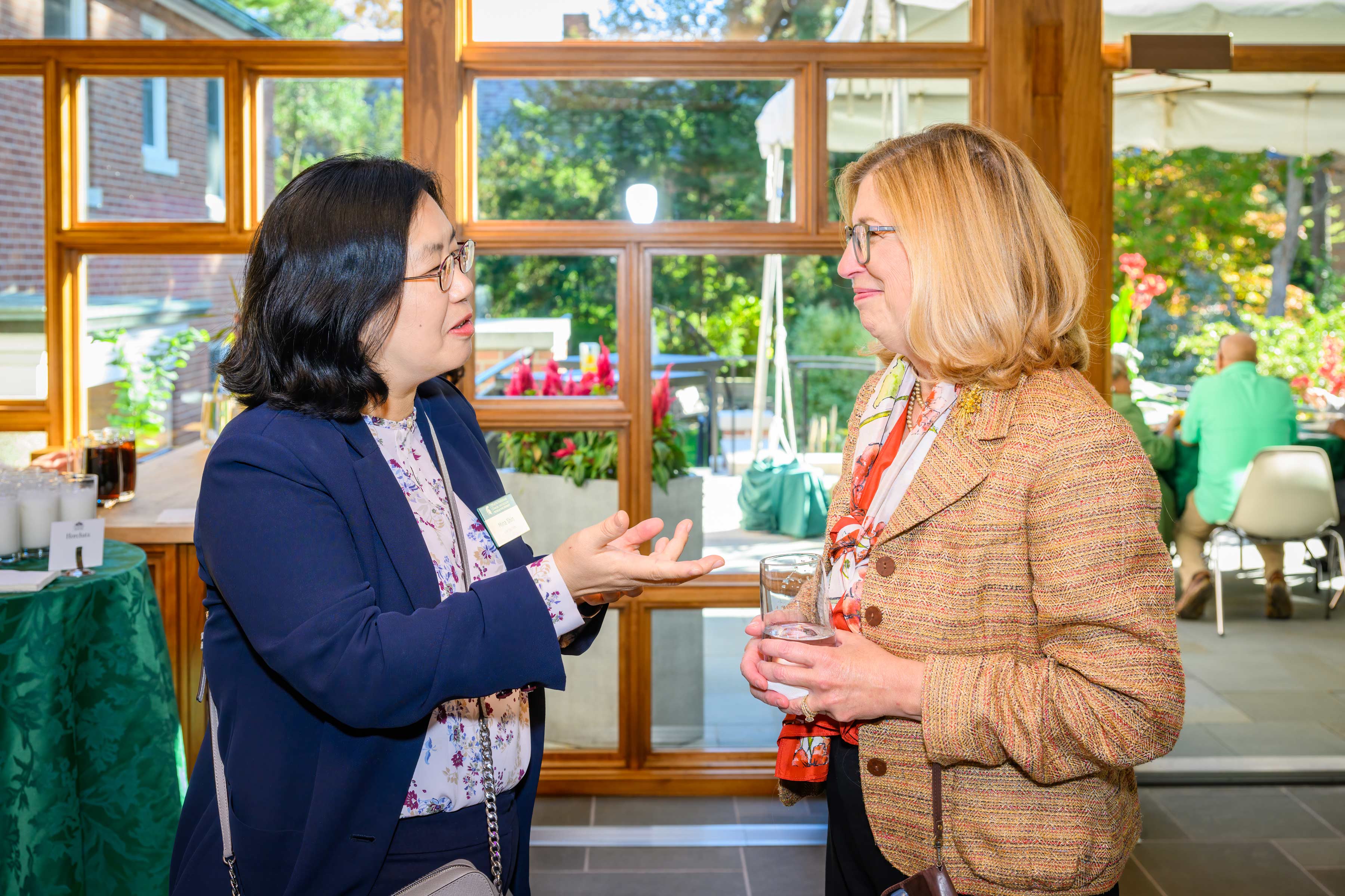 Mina Shin, Ph.D., DEI learning development specialist in Institutional Diversity and Inclusion (left) and Teresa K. Woodruff, provost and executive vice president of academic affairs, having a conversation.
