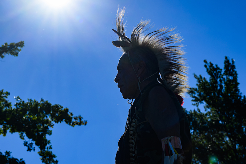 Photo of silhouette of a dancer wearing a headdress.