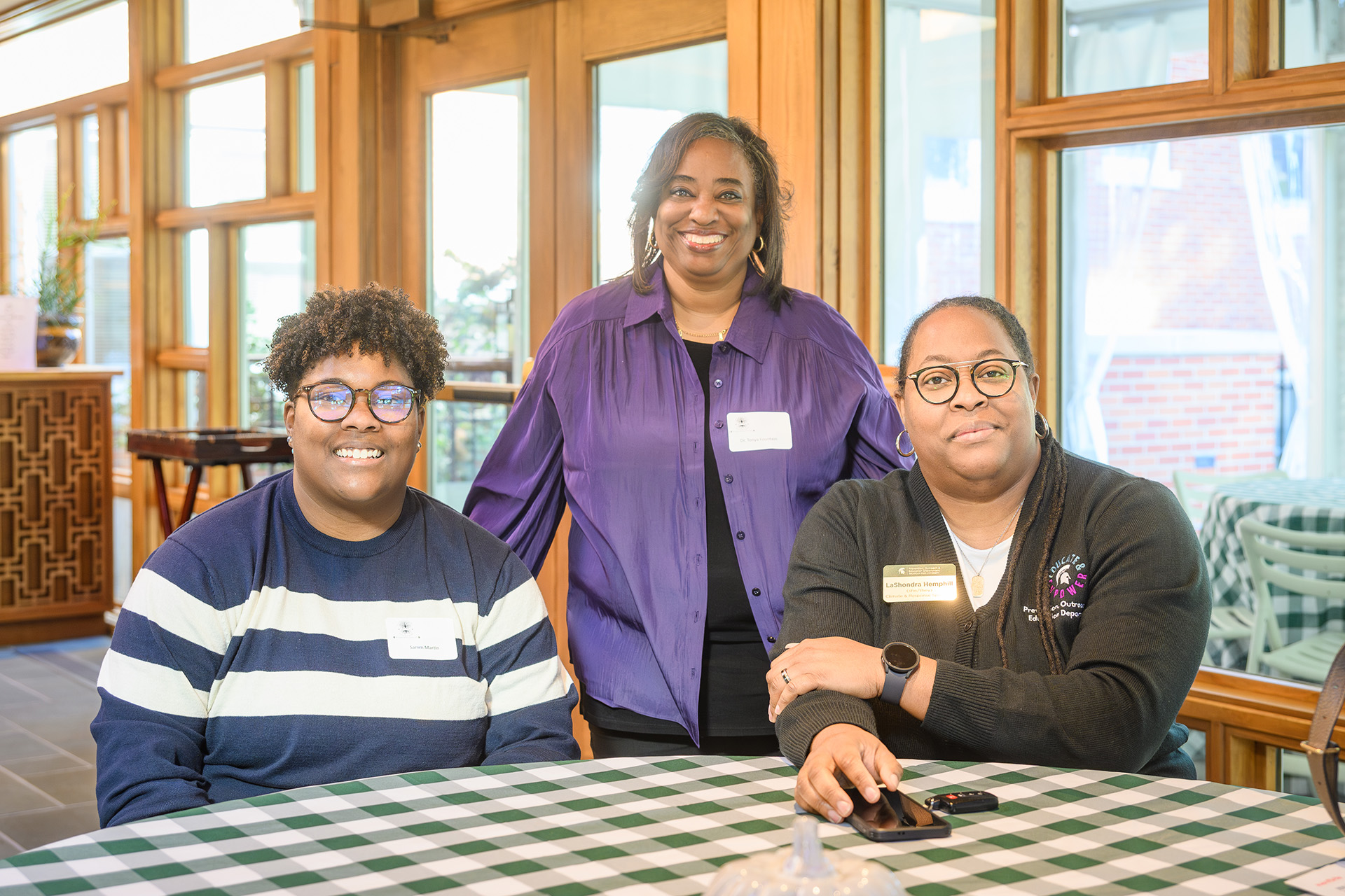 Photo of three employees around a table