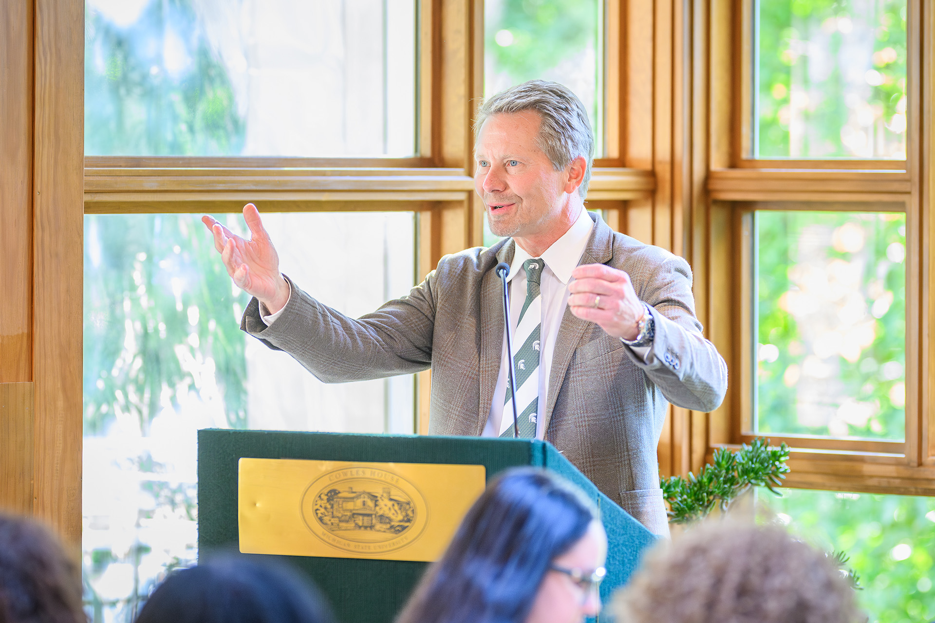 Kevin Guskiewicz gestures while speaking to the room