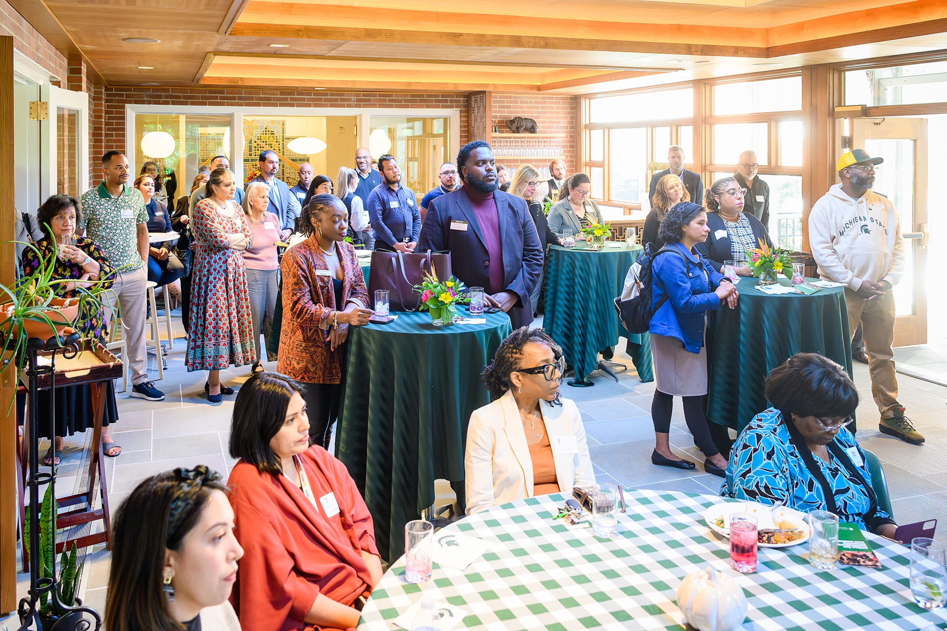 Attendees listen to remarks in the room