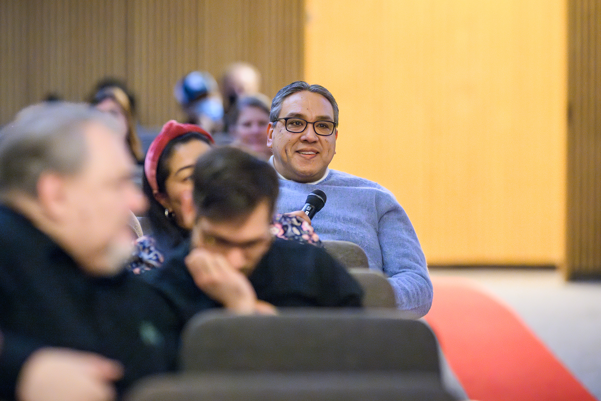 an audience member poses a question to the speaker