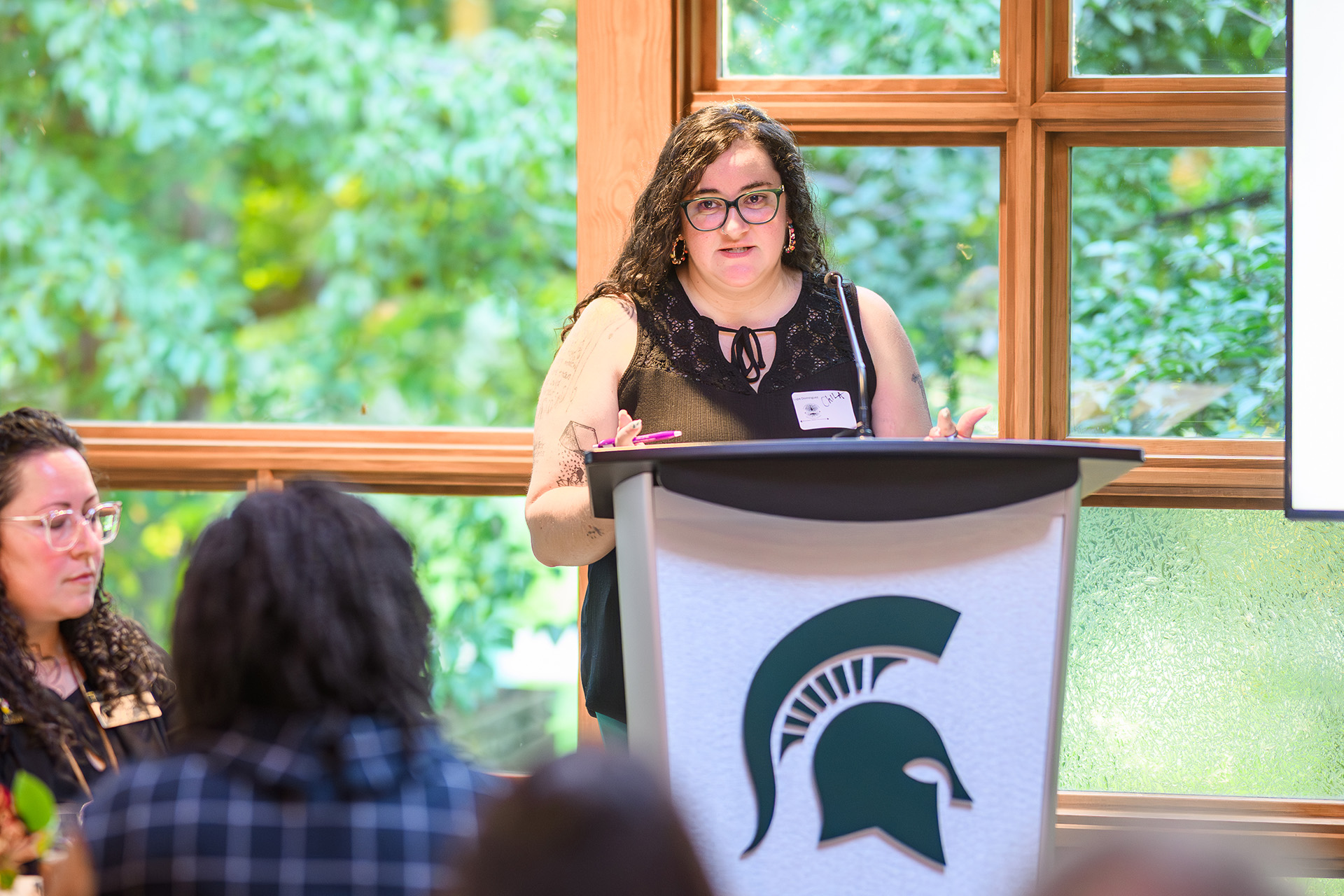 a woman speaks at the lectern