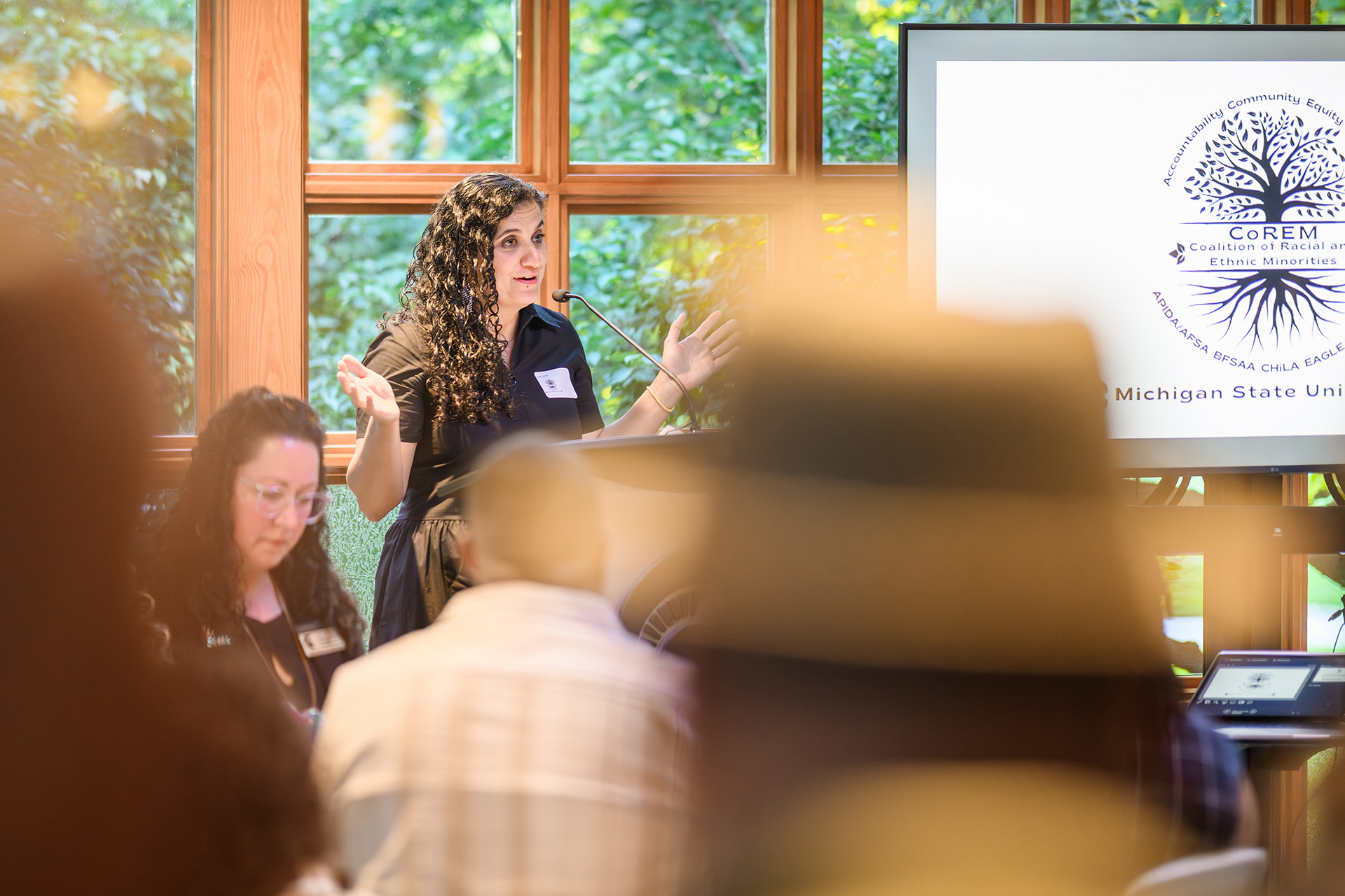 a woman speaks at the lectern