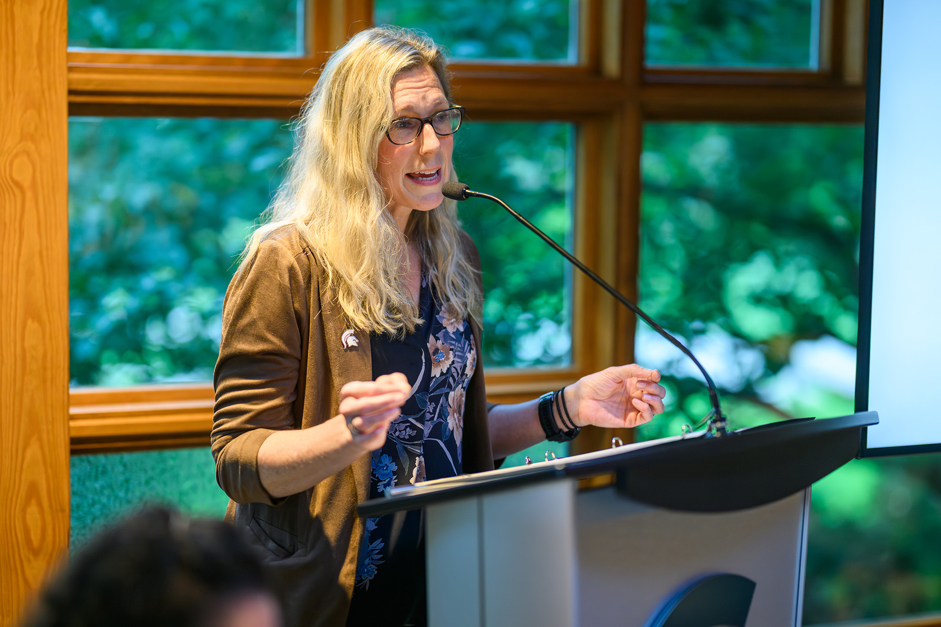 a woman speaks at the lectern
