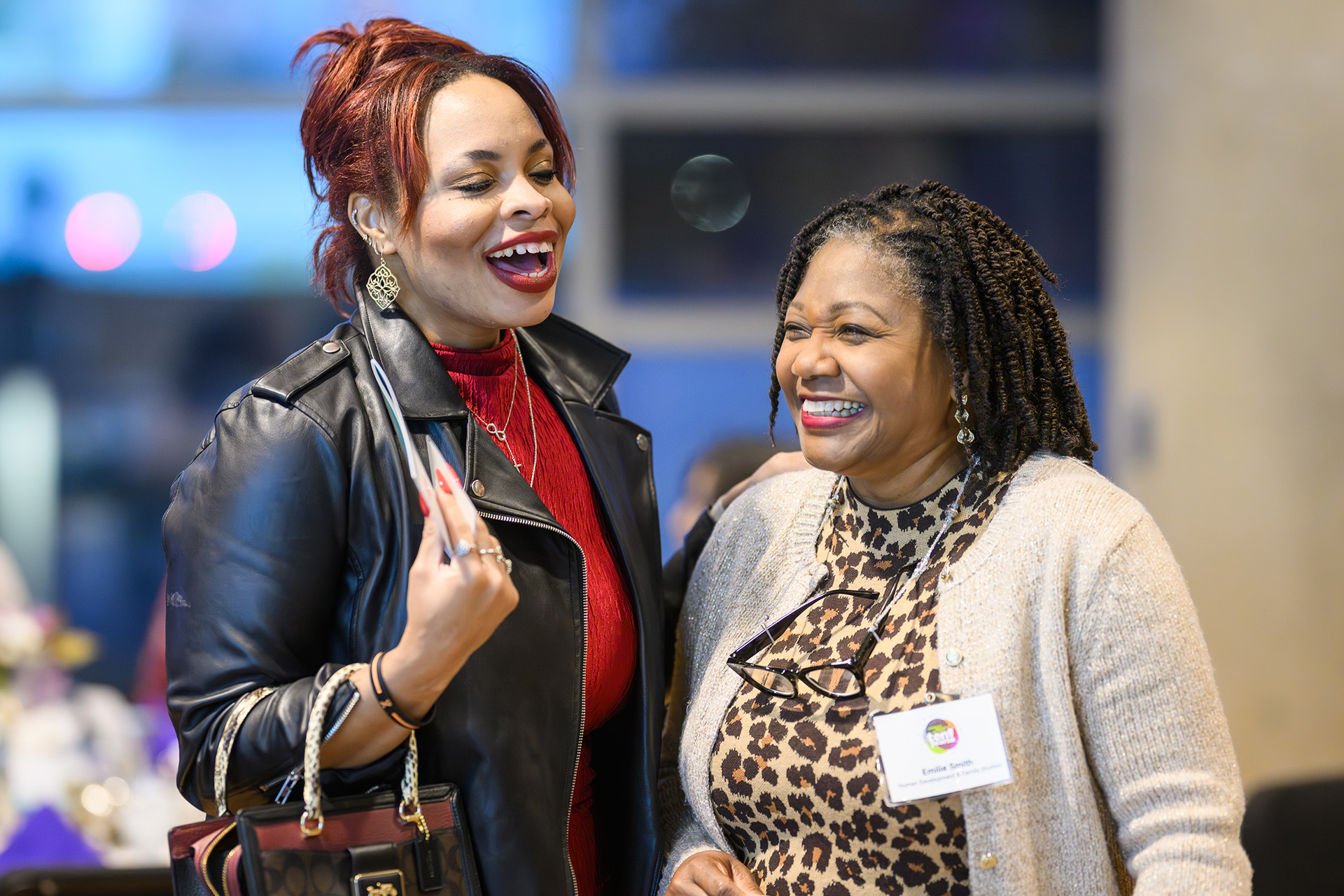 two women smiling and sharing laughter
