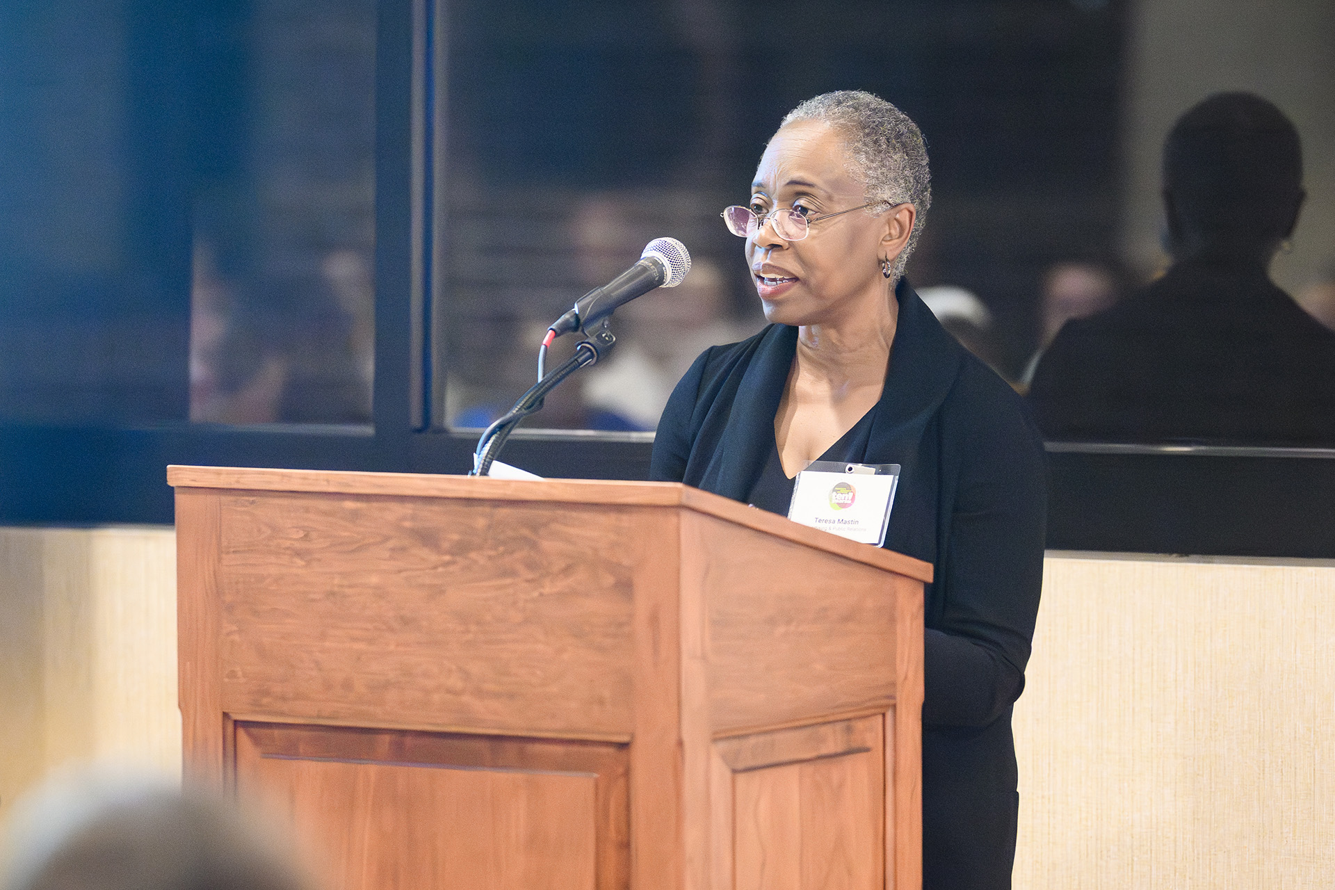 a woman speaks at the lectern