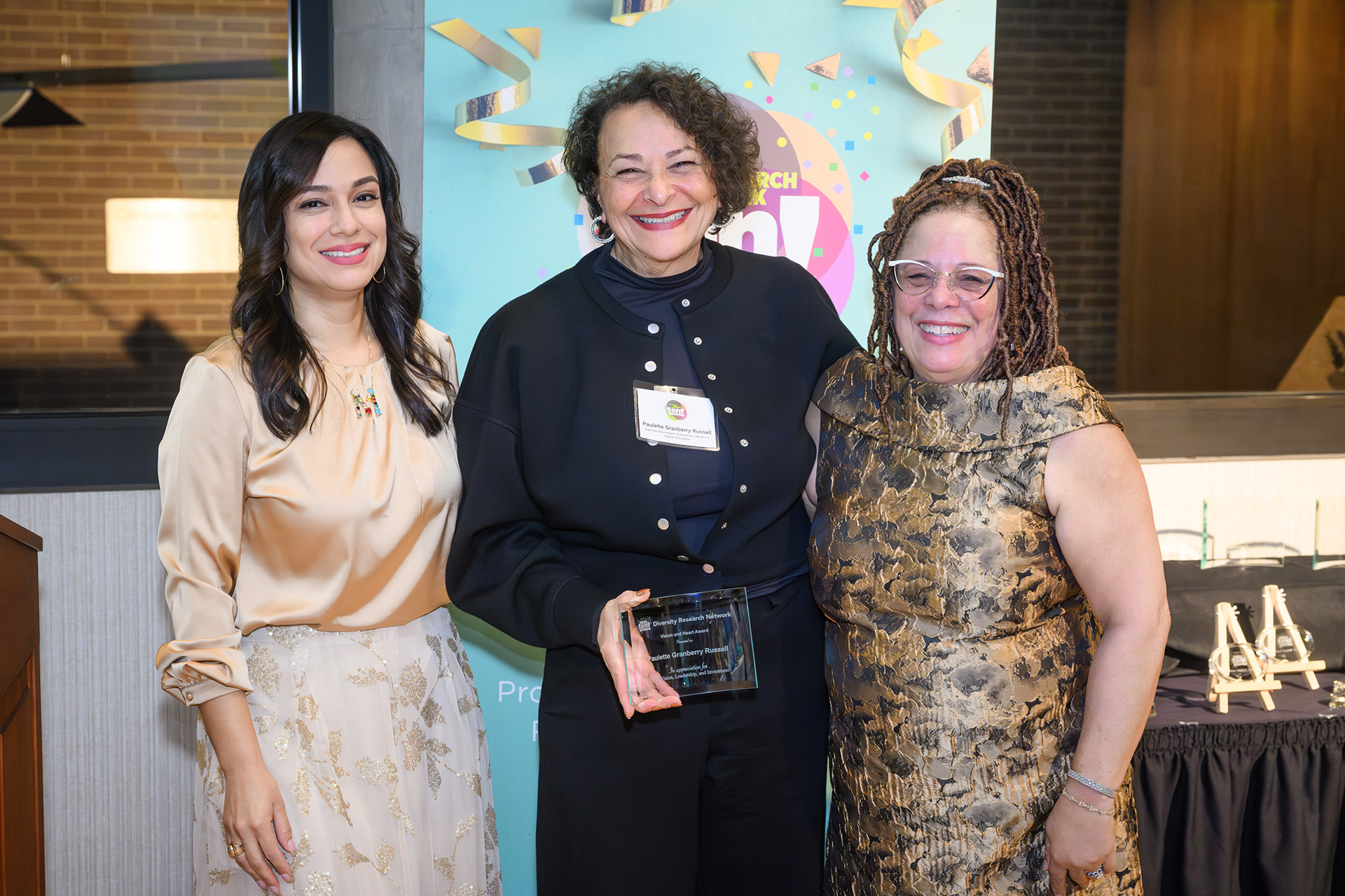 an awardee receives a plaque