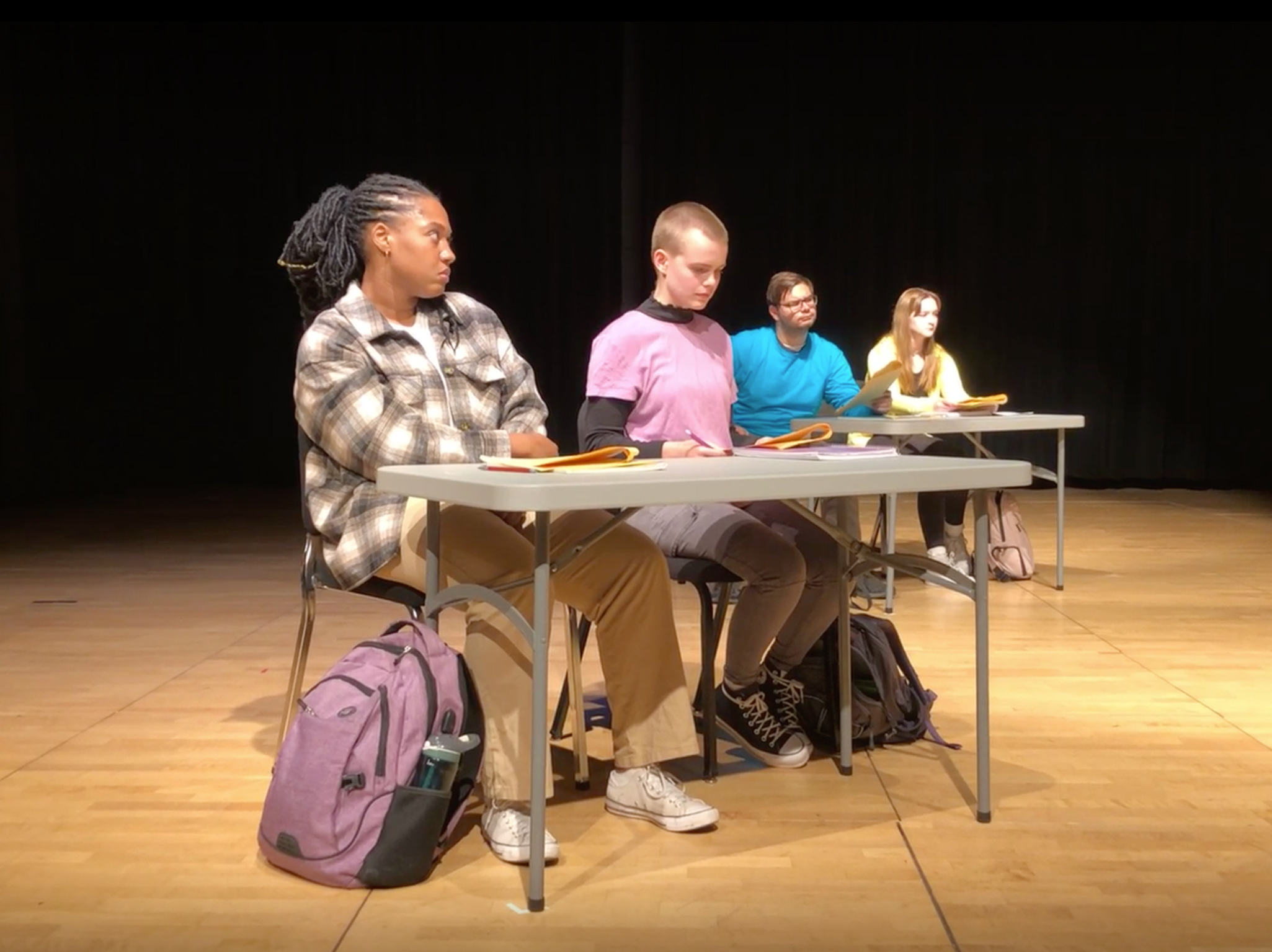 Main character Olamina (left) sits in a modern day classroom, portraying to the audience how Black students are treated.