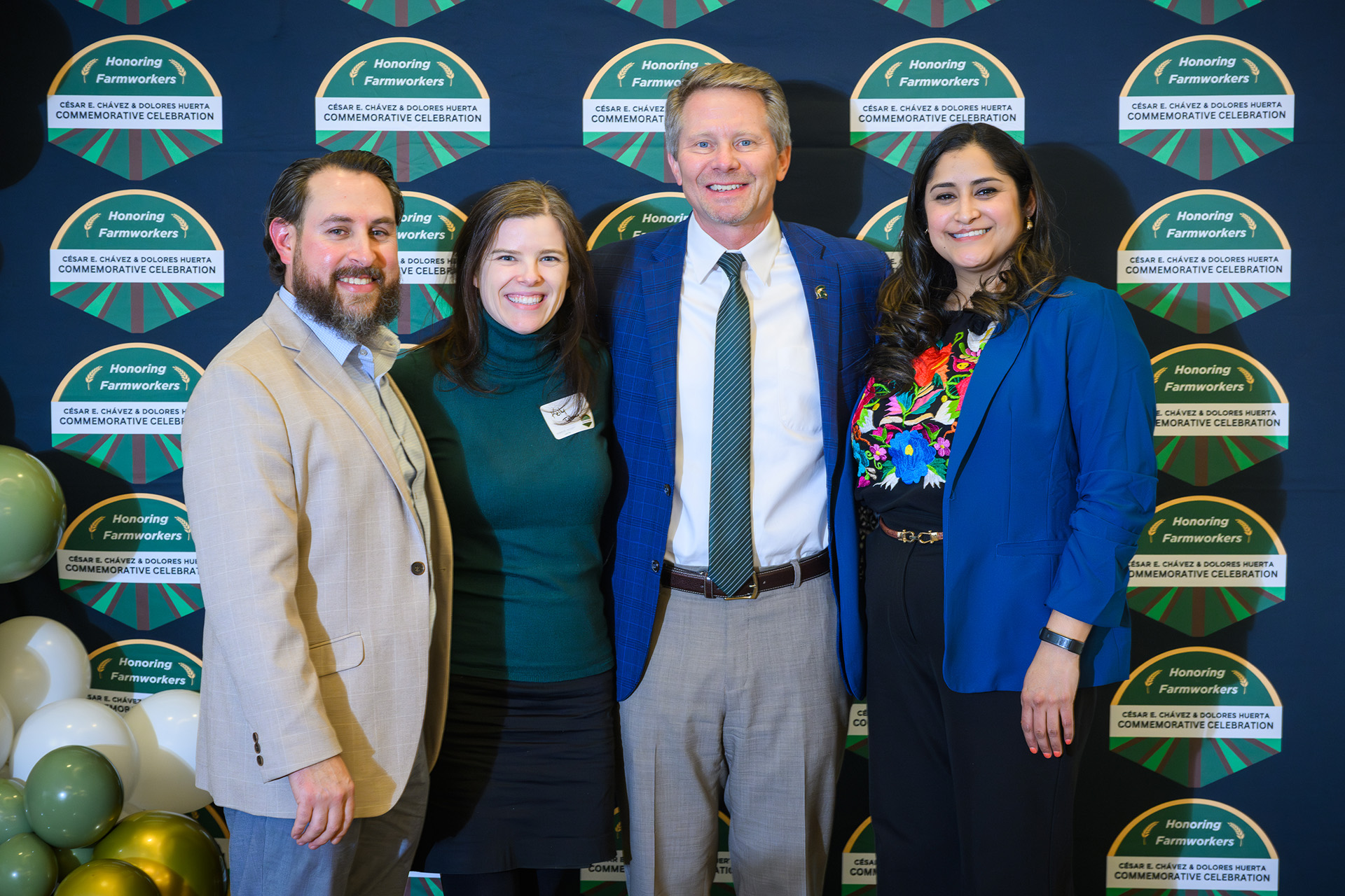 committee co-chairs take a photo with the university president and board of trustee member