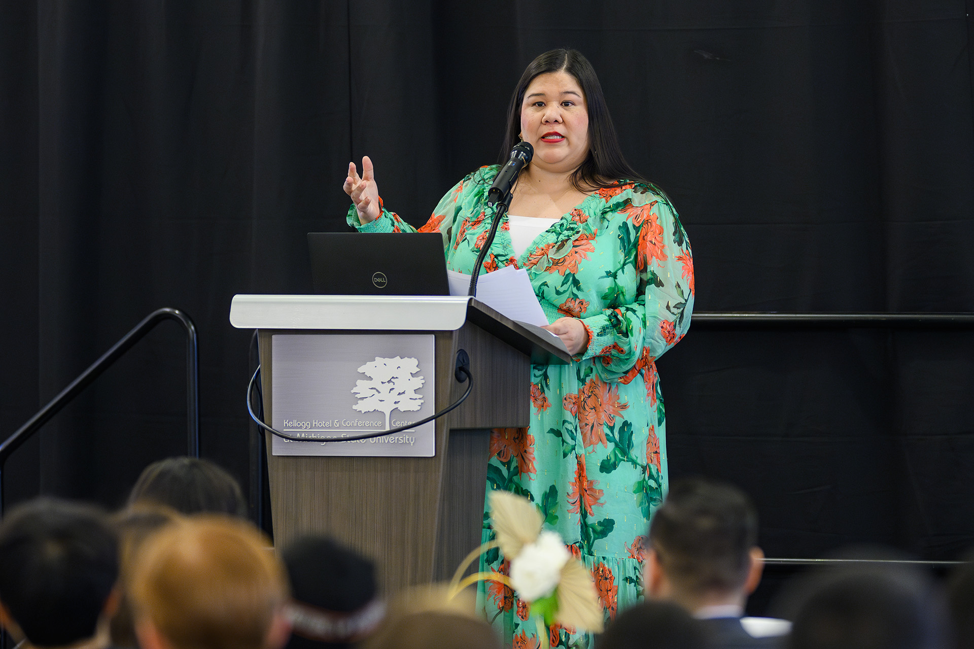 keynote speaker addresses the audience while standing at the lectern