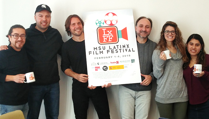 Latinx Film Festival team posses with poster for the festival