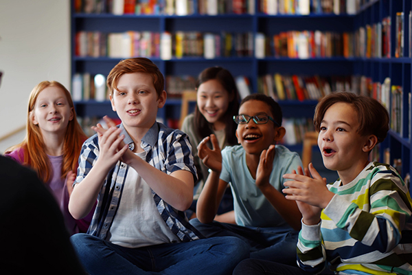 kids in a library clapping for the story