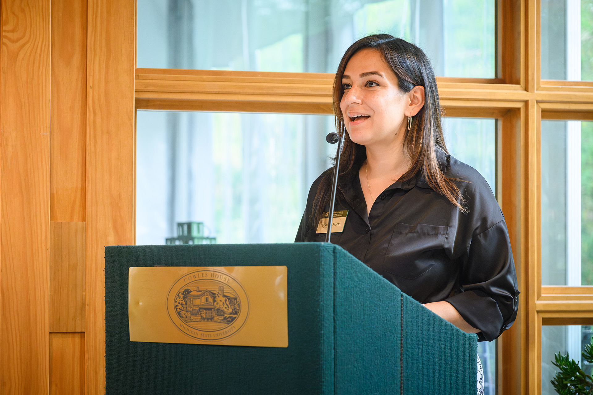 Micaela Flores speaking at the lectern