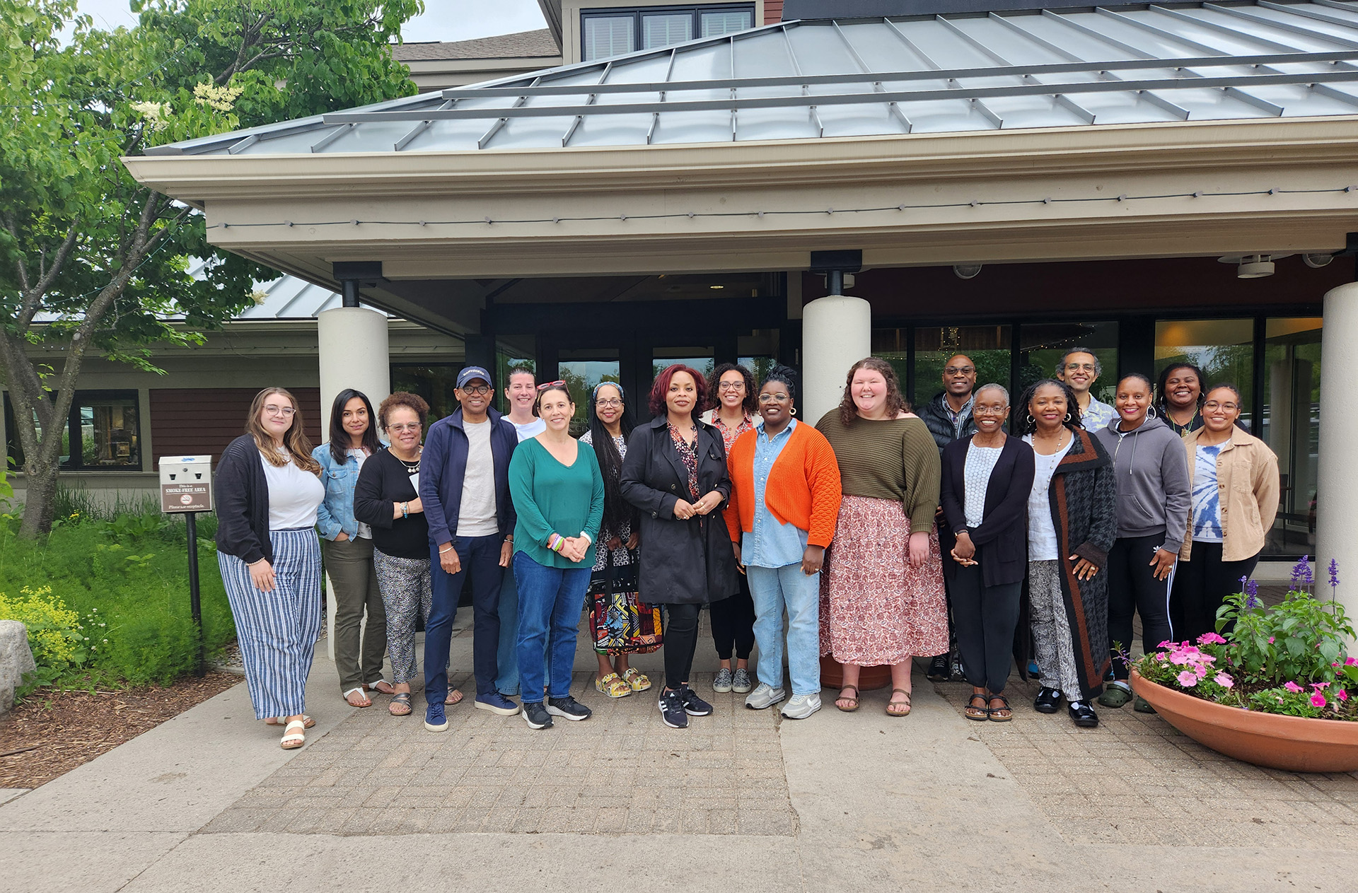 group of participants standing outside in front of a building