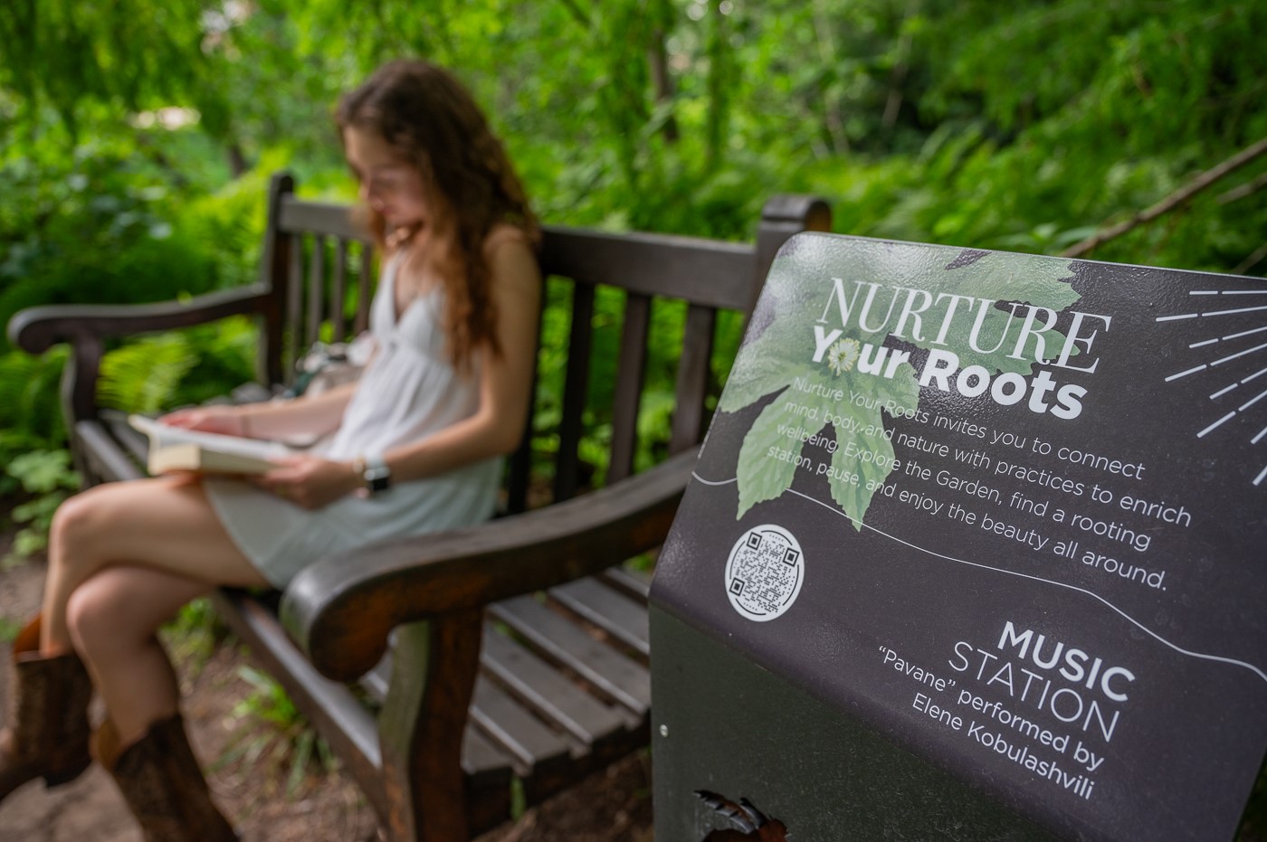 a student reads on a bench in the Beal Botanical Garden